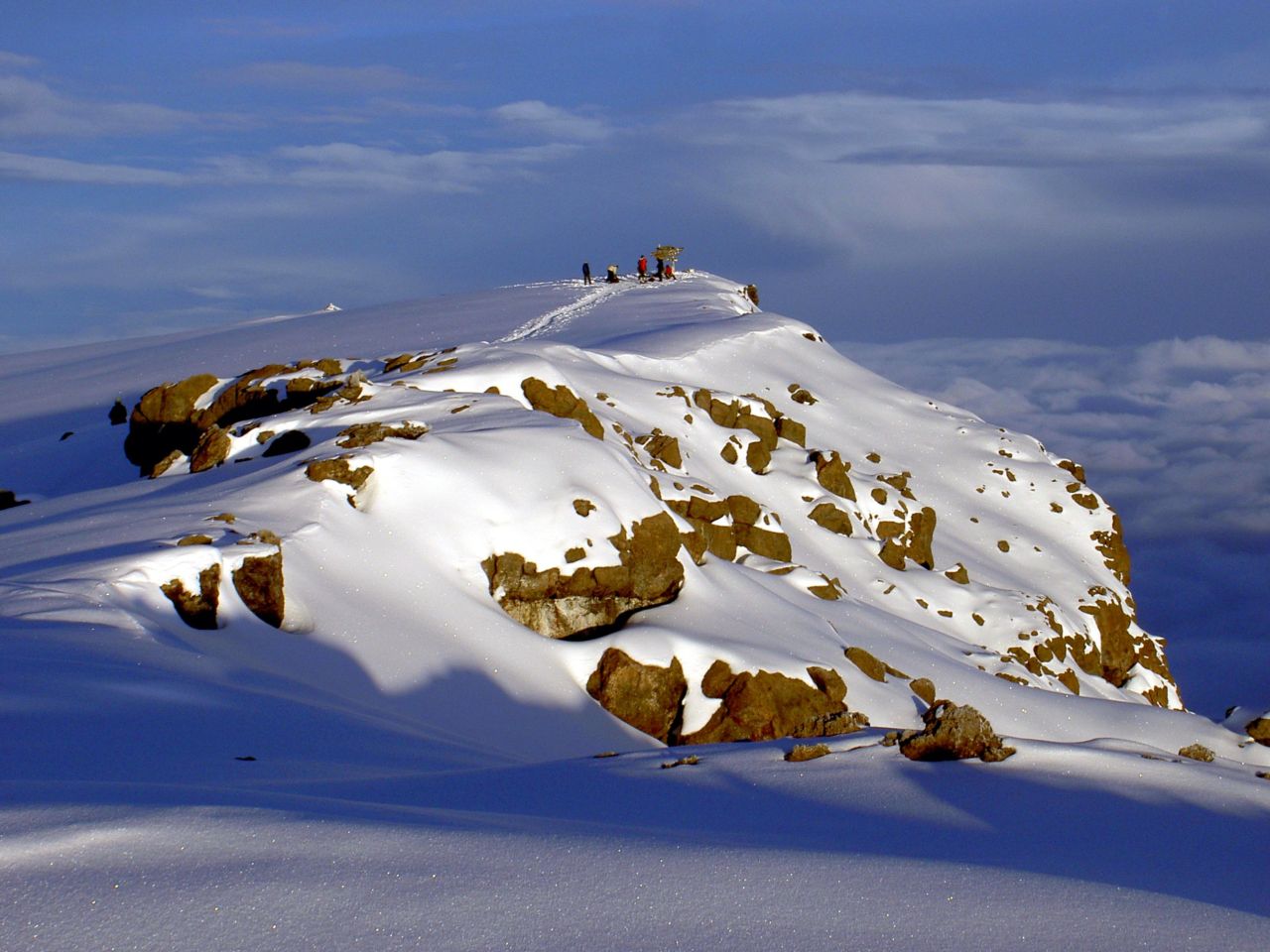 Snow and dark rock on the summit plateau of Kilimanjaro