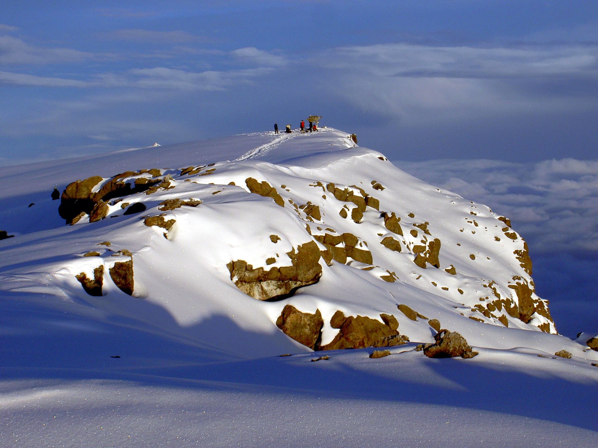 Snow and dark rock on the summit plateau of Kilimanjaro