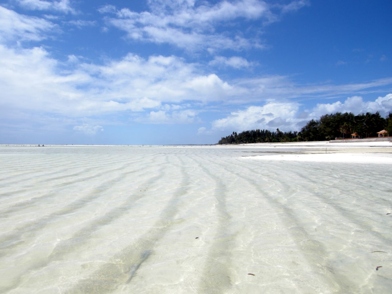 Rippled white sand at low tide on a Zanzibar beach